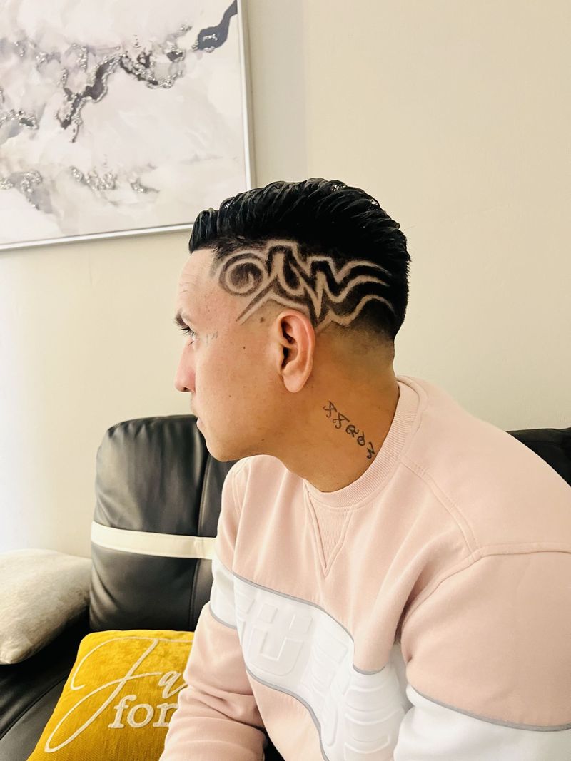 Wave pattern hair design with a taper fade
